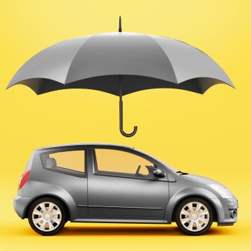 Car under an umbrella against a yellow background